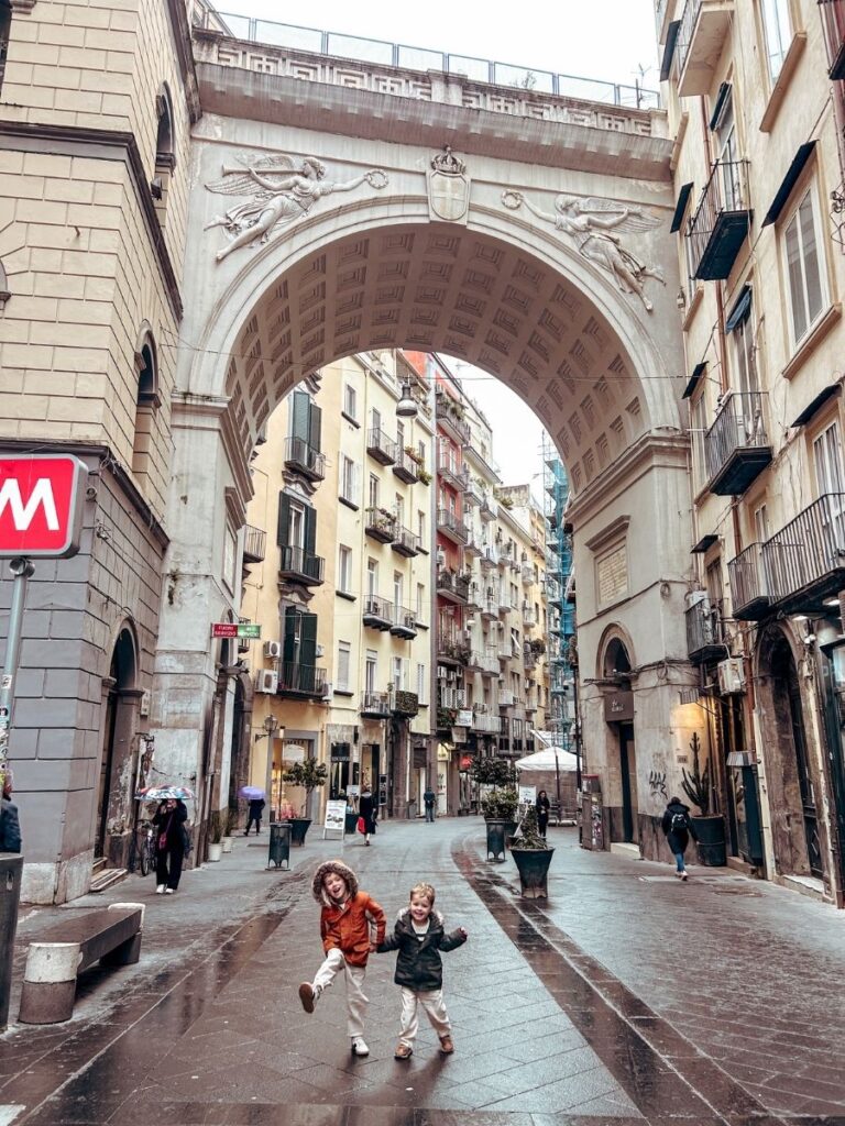 Children exploring the historic centre on a family trip to Naples.