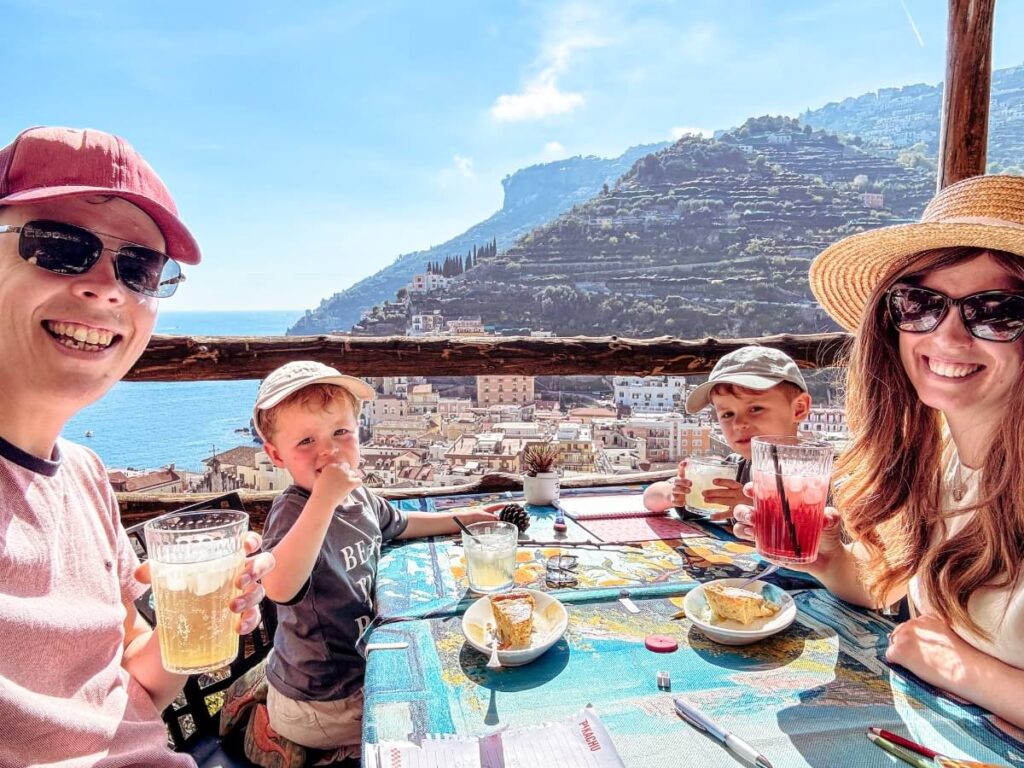 Family enjoying a drink and cake at restaurant CUONC CUONC on the Path of the Lemons.
