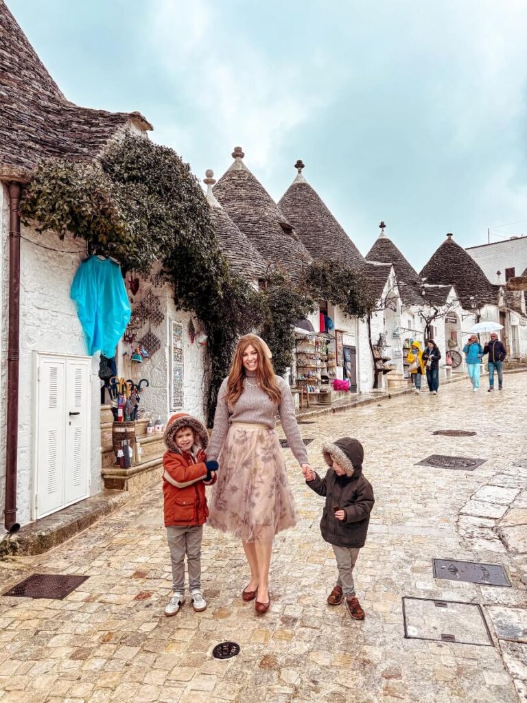 Mum in the City and her kids, exploring the  Rione Monti area, one of the best things to do in Alberobello, Italy. 