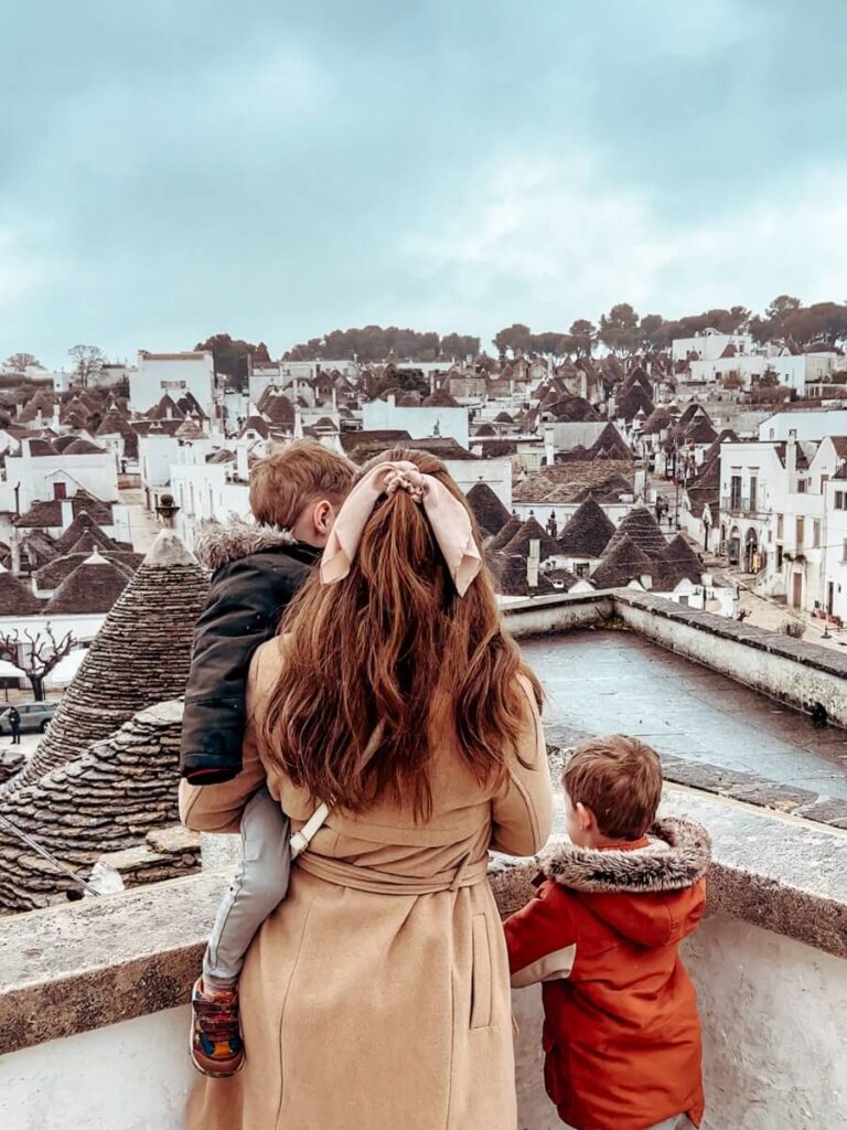 Family gazing out over the views of the trullis in Alberobello.