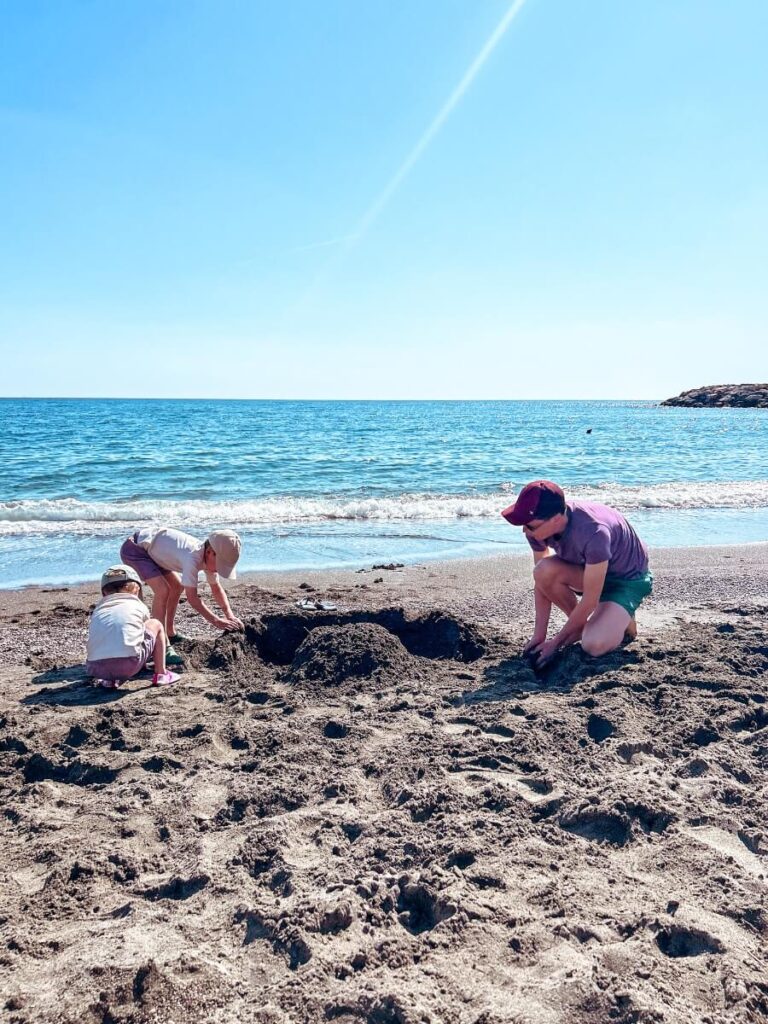 Family playing on Maiori Beach during a trip to the Amalfi Coast.