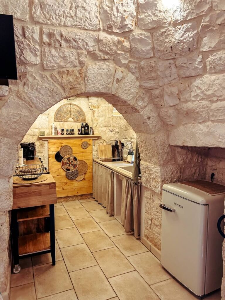 The cute kitchen area inside our Alberobello Trulli stay.
