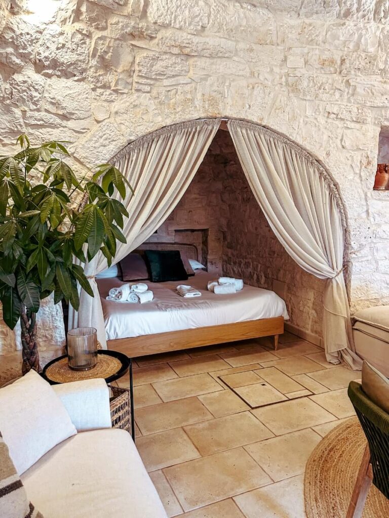 The bedroom area inside a trulli stay in Alberobello.
