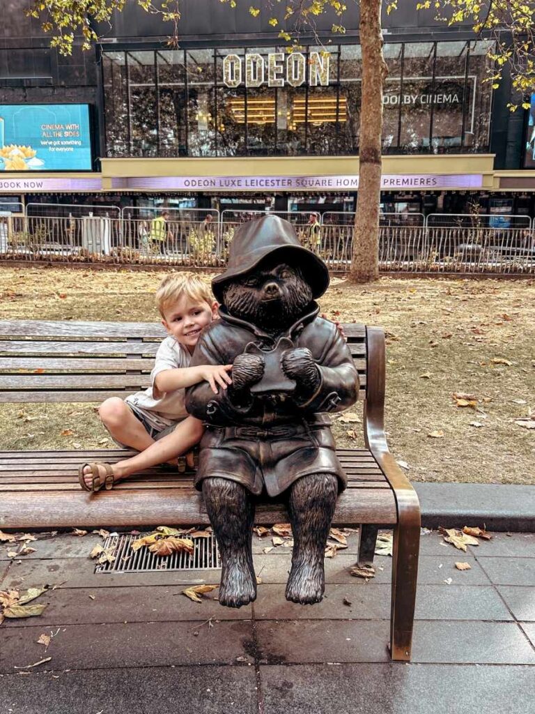 Kids enjoying the Scenes in the Square trail, Paddington Bear sculpture in 
Leicester Square