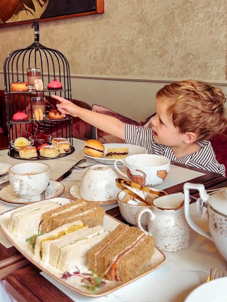 My son enjoying the Tales and Teacups afternoon tea in London's DoubleTree West End Hotel.