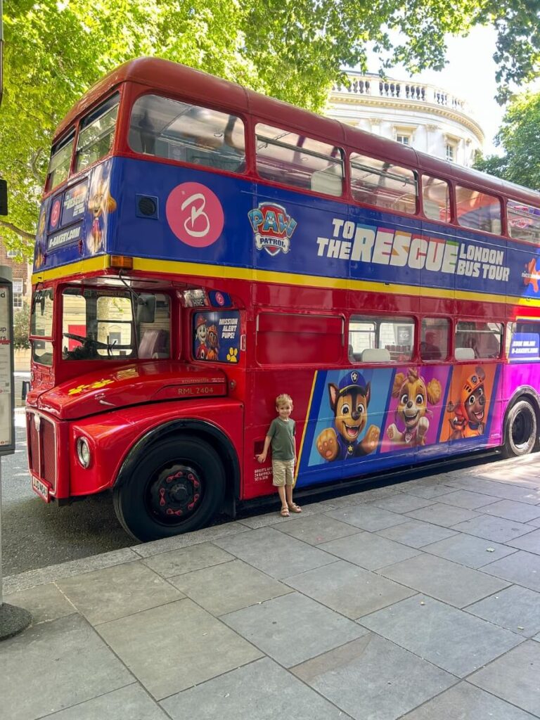 View of a child stood in front of the Paw Patrol Afternoon tea bus. An incredible activity for families in London. 